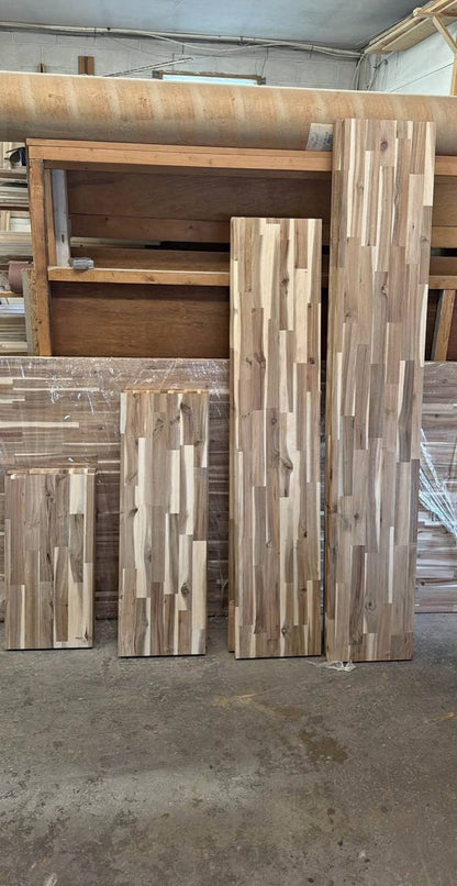 Acacia butcher block countertop slabs standing in the Palm Beach Butcher Block shop